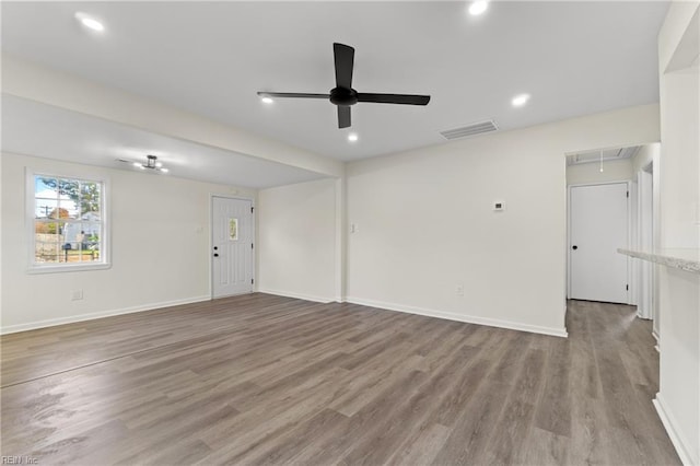 unfurnished living room featuring ceiling fan and light hardwood / wood-style flooring