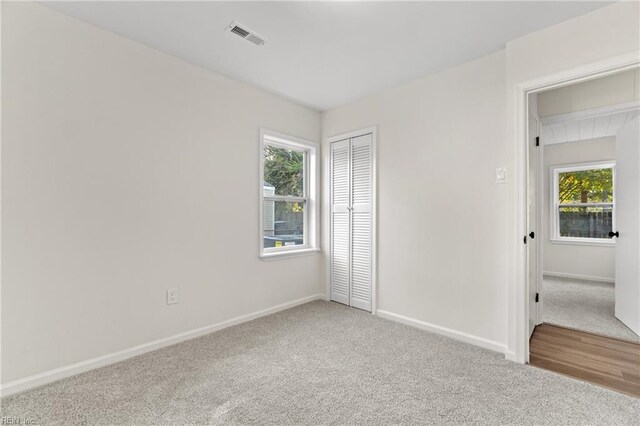 unfurnished bedroom with a closet and carpet flooring