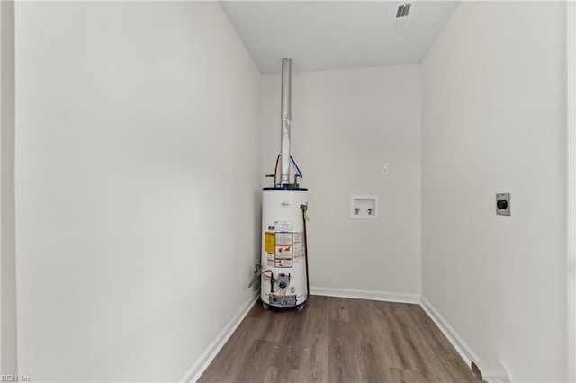 clothes washing area featuring water heater, hookup for a washing machine, electric dryer hookup, and hardwood / wood-style floors