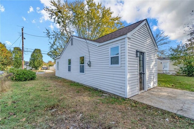 view of property exterior featuring a yard and a patio