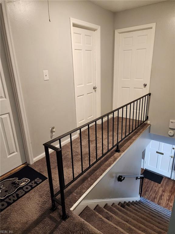 stairway featuring wood-type flooring