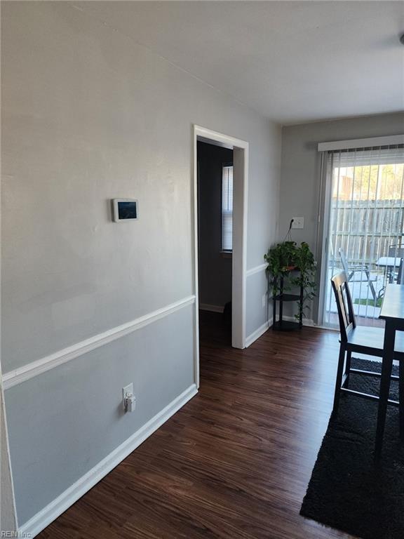 dining space with dark hardwood / wood-style flooring