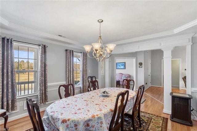 dining room featuring plenty of natural light, crown molding, and light wood-type flooring