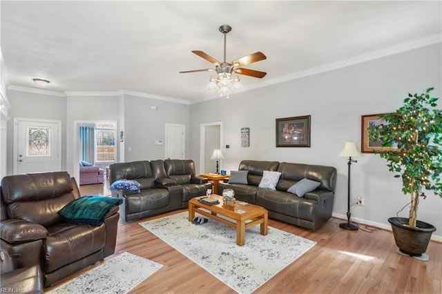 living room with ceiling fan, ornamental molding, and light hardwood / wood-style flooring