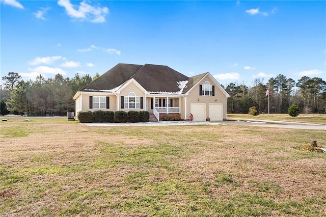 view of front of property featuring covered porch, a front lawn, and a garage