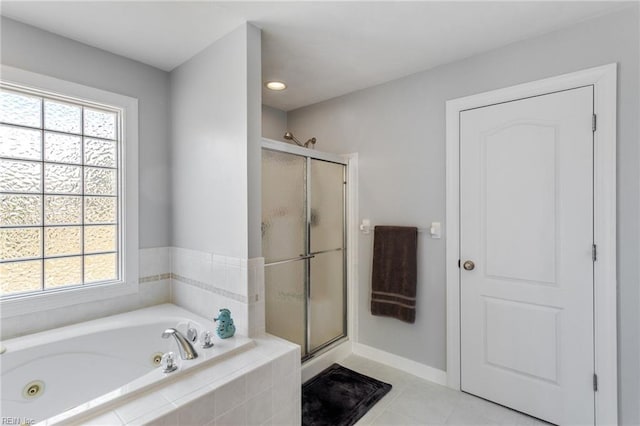 bathroom with tile patterned floors and shower with separate bathtub