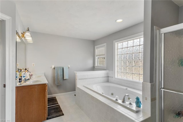 bathroom with vanity, tile patterned flooring, and plus walk in shower