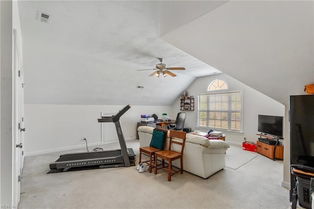 workout area featuring ceiling fan, lofted ceiling, and light carpet