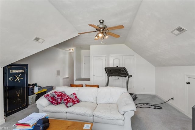 living room featuring ceiling fan, light colored carpet, and vaulted ceiling