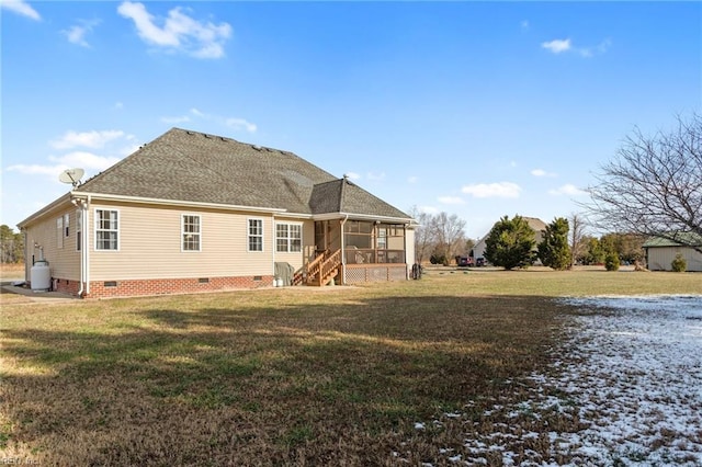 rear view of house with a lawn and a sunroom