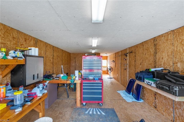 interior space featuring wood walls and a workshop area