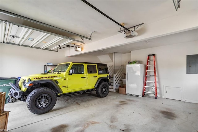 garage with a garage door opener and electric panel