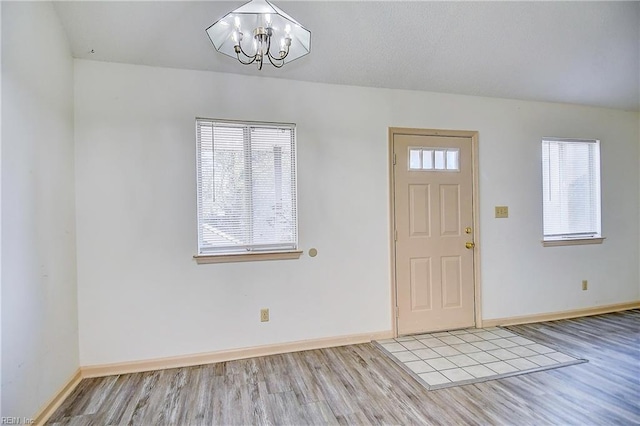 entryway featuring an inviting chandelier and light hardwood / wood-style floors