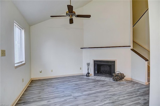 unfurnished living room with ceiling fan, vaulted ceiling, and hardwood / wood-style floors