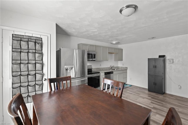 dining space featuring hardwood / wood-style floors and sink