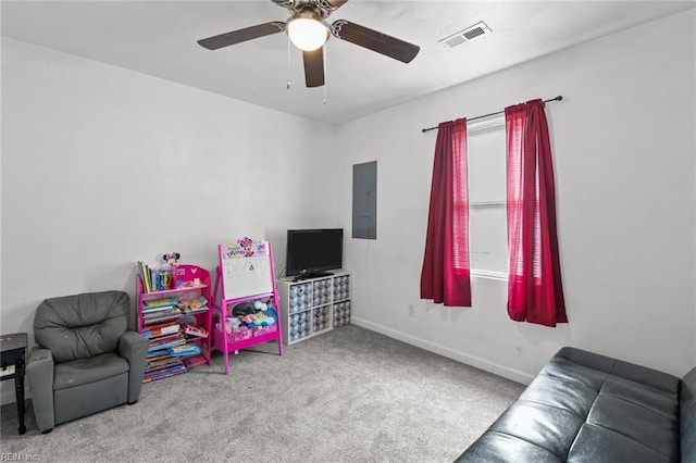 recreation room featuring ceiling fan, light colored carpet, and electric panel