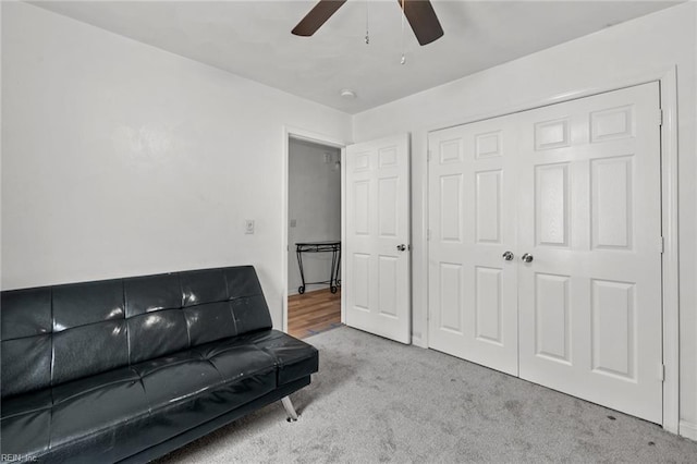 interior space featuring ceiling fan and light colored carpet