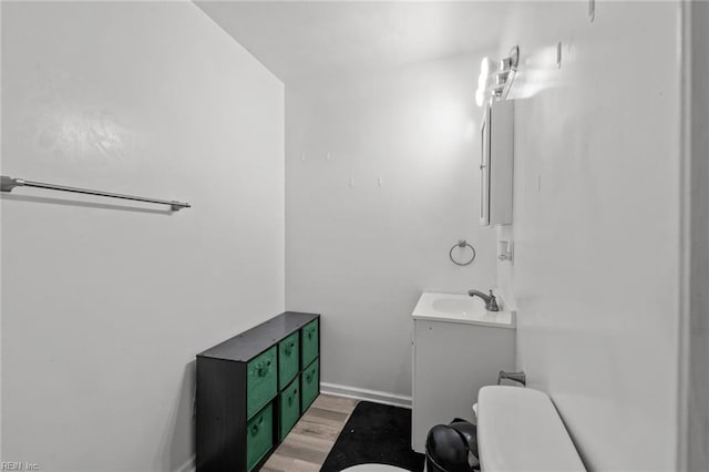 bathroom featuring hardwood / wood-style floors, vanity, and toilet