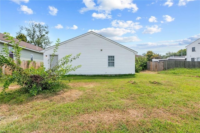 view of side of home with a yard