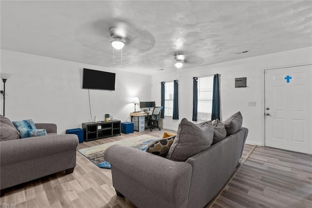 living room with hardwood / wood-style floors and ceiling fan