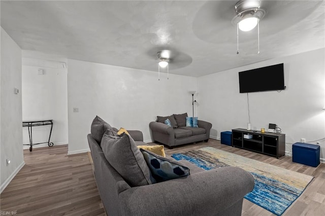 living room with ceiling fan and hardwood / wood-style flooring