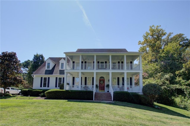 view of front of home featuring a porch, a front yard, and a balcony