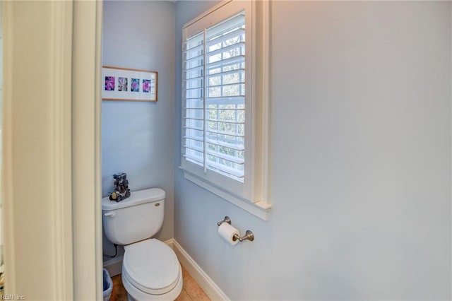 bathroom with toilet and tile patterned floors