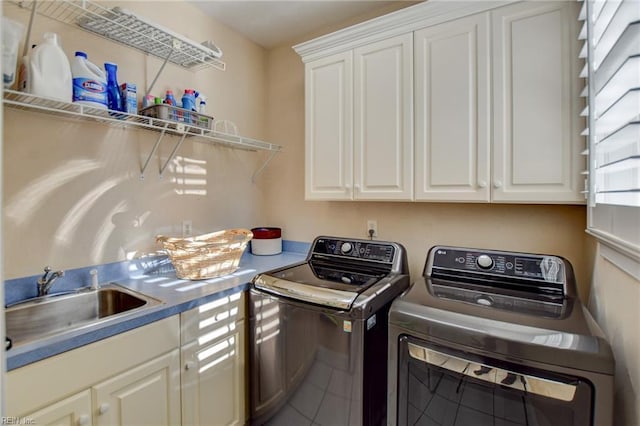 laundry room featuring sink, cabinets, separate washer and dryer, and tile patterned flooring