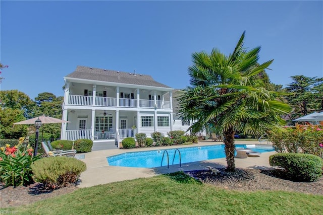 back of property featuring ceiling fan and a patio area