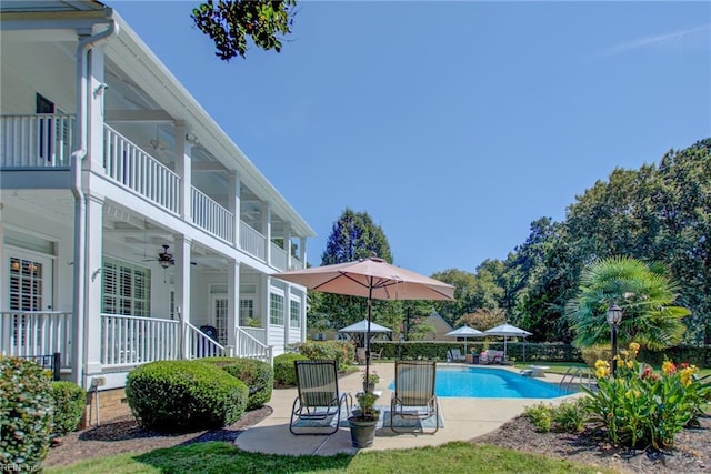 view of pool with ceiling fan and a patio