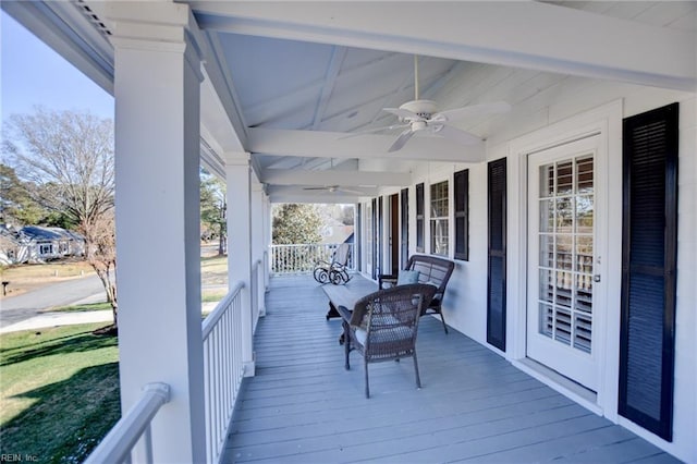 deck with ceiling fan and covered porch