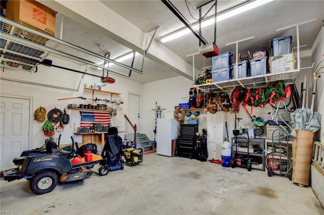 garage featuring a garage door opener and a workshop area