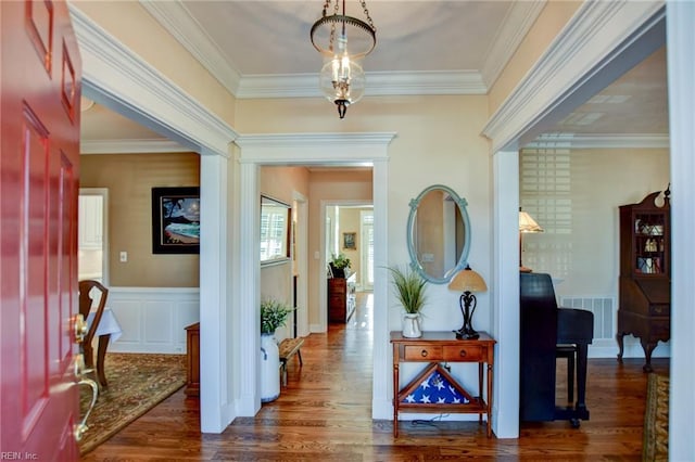 entryway with crown molding and dark hardwood / wood-style floors