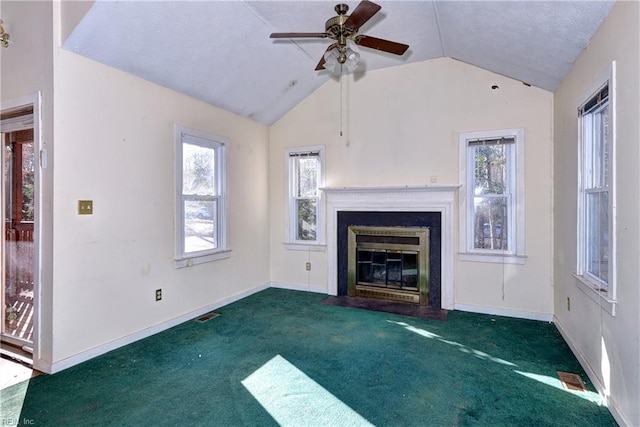 unfurnished living room featuring ceiling fan, lofted ceiling, and dark carpet