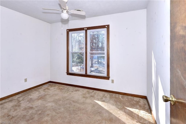 empty room with ceiling fan and light colored carpet