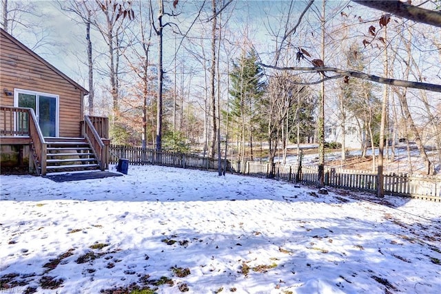 snowy yard with a wooden deck