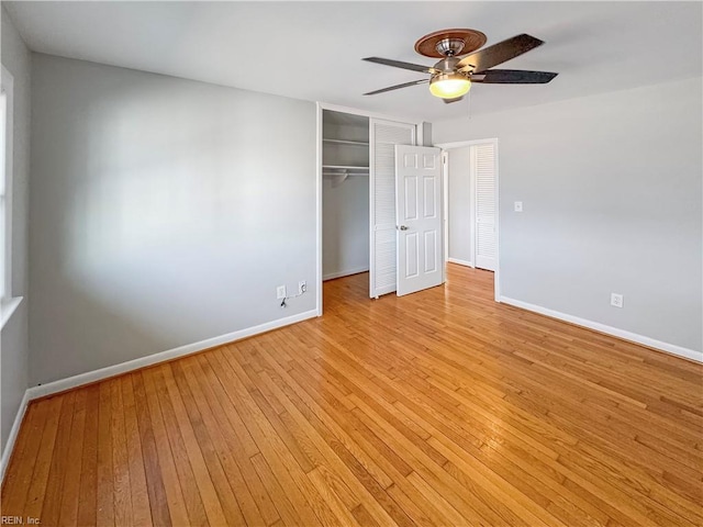 unfurnished bedroom featuring ceiling fan, a closet, and light wood-type flooring