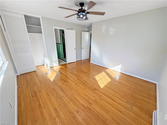 unfurnished bedroom with ceiling fan and light hardwood / wood-style floors