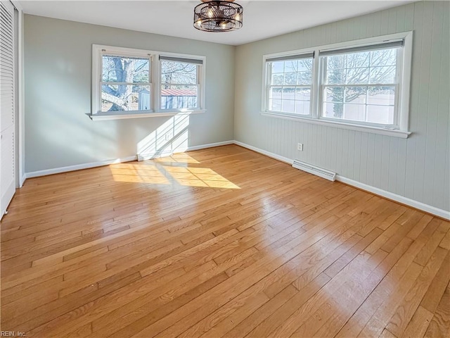 unfurnished dining area featuring light hardwood / wood-style flooring and an inviting chandelier