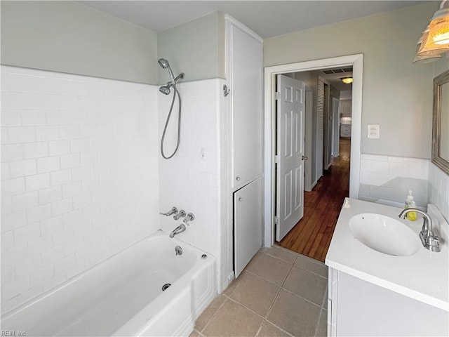 bathroom with tile patterned flooring, vanity, and shower / washtub combination