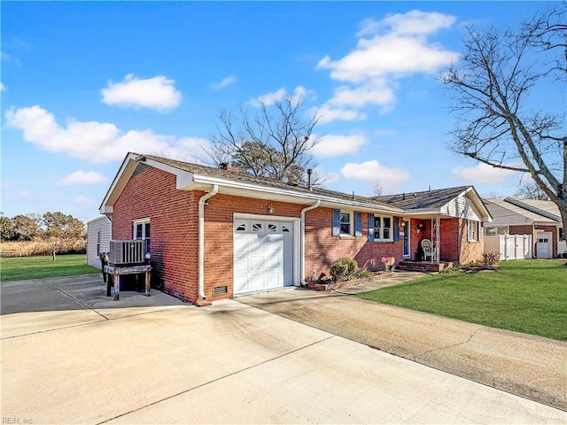 ranch-style home featuring a garage, a front lawn, and central air condition unit