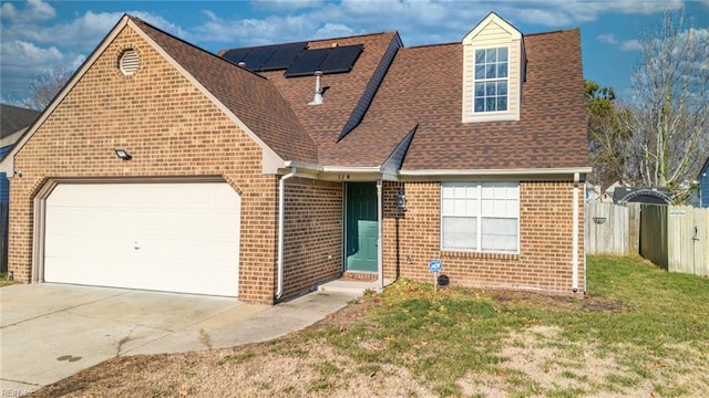 view of front of home featuring solar panels, a garage, and a front yard