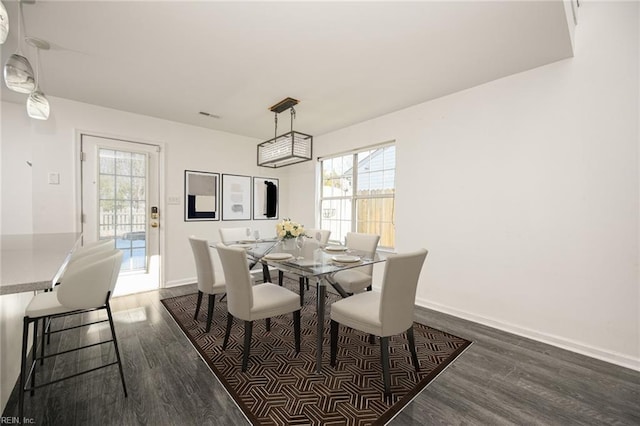 dining space with dark wood-type flooring