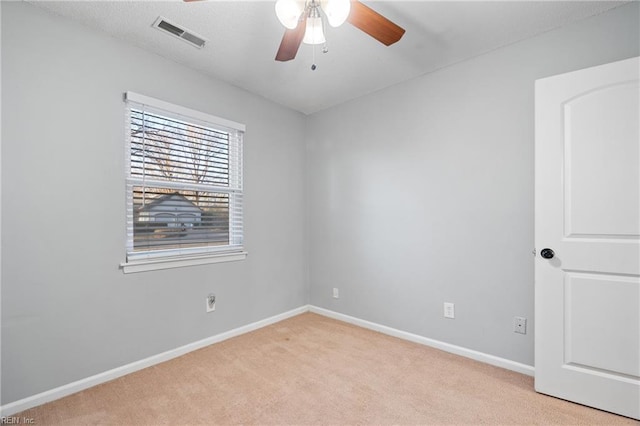 carpeted empty room featuring ceiling fan