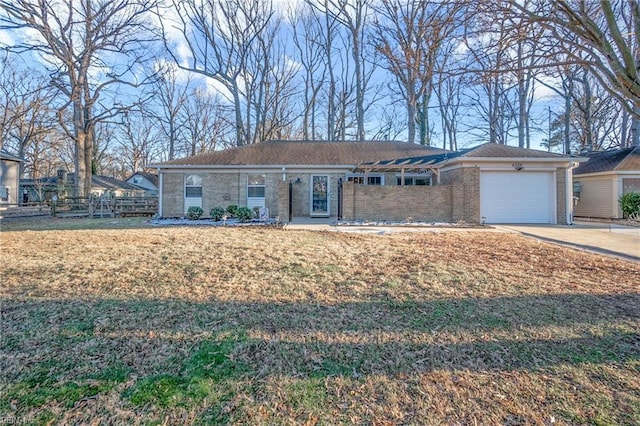 single story home with a front yard and a garage