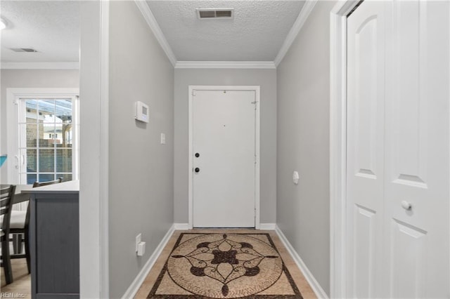 doorway to outside featuring a textured ceiling and ornamental molding