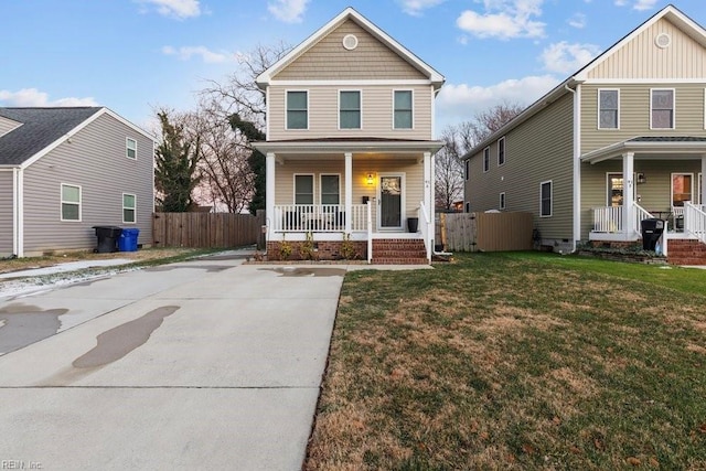 view of property featuring covered porch and a front yard