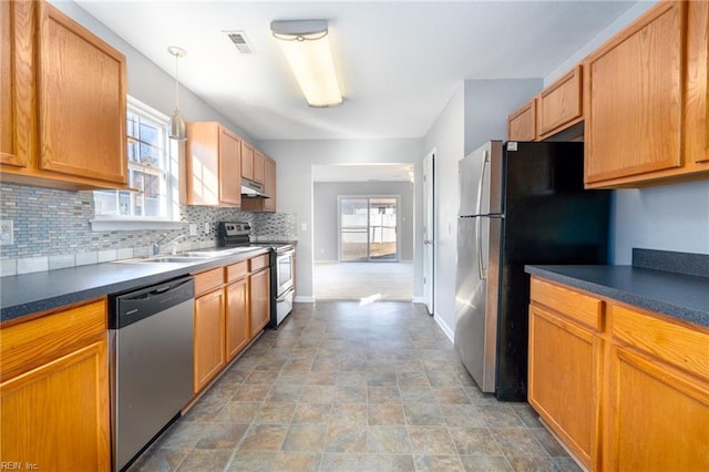 kitchen featuring decorative light fixtures, a healthy amount of sunlight, sink, and stainless steel appliances