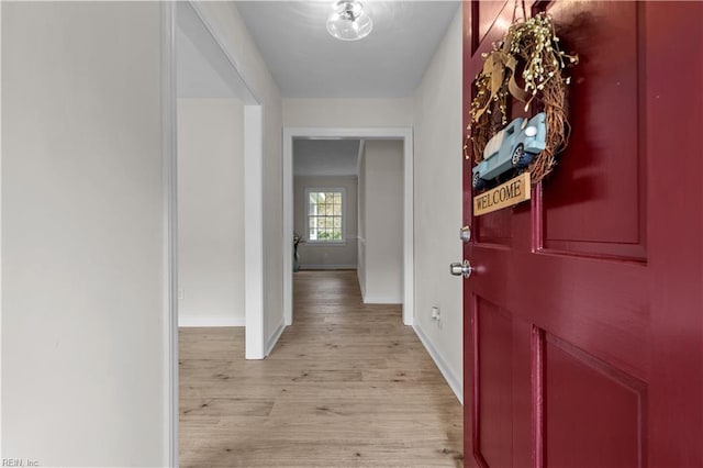 corridor with light hardwood / wood-style flooring