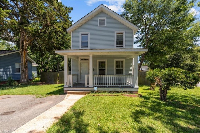 view of front of property featuring covered porch and a front yard